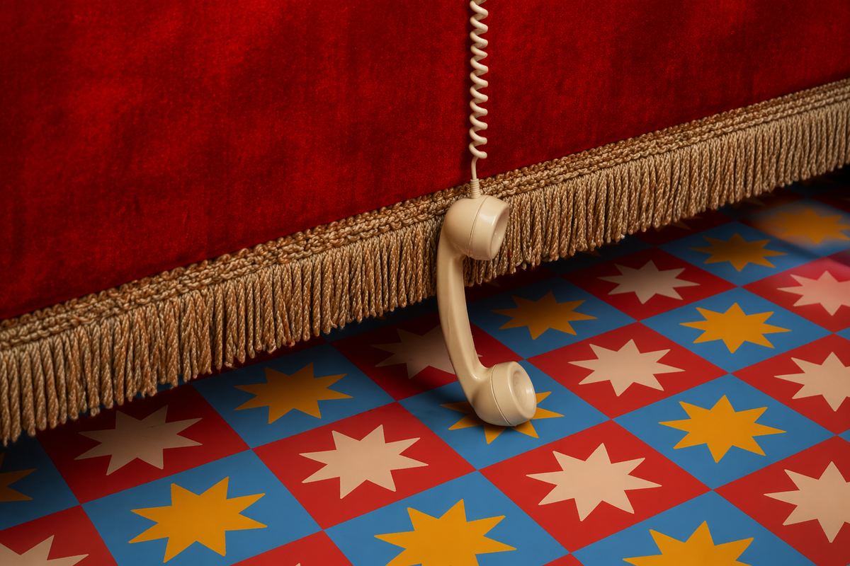 Red velvet chair above a colourful star-patterned floor