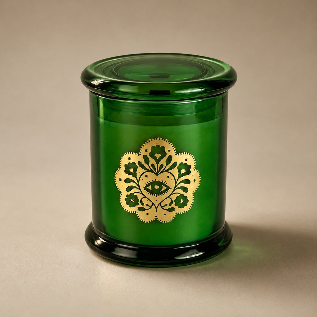 Miss Sparkle soy candle in a green glass vessel with its lid on