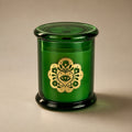Miss Sparkle soy candle in a green glass vessel with its lid on